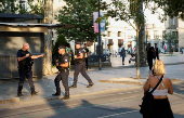 Police officers patrol on the day of the Opening Ceremony of the Paris 2024 Olympics, in Saint-Etienne