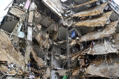 People check damaged buildings after Israeli military strikes on Beirut