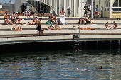 People relax on Melbourne St Kilda beach