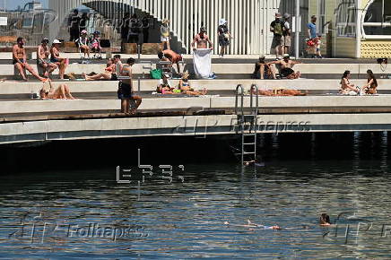 People relax on Melbourne St Kilda beach