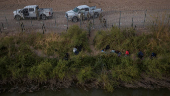 Army National Guard soldiers survey razor wire fence breached by migrants in El Paso