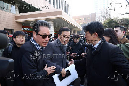 Seok Dong-hyeon, a lawyer for South Korea's impeached President Yoon Suk Yeol, is surrounded by media upon his arrival at a court, in Seoul