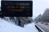 A sign displays a warning at the side of the A9 near Aviemore, Scotland