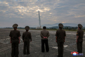 North Korean leader Kim Jong-un looks on during the test of what KCNA described as a new tactical ballistic missile