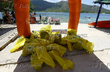 Activists and volunteers collect garbage during the cleanup operation as part of World Beach Day, in La Cienega