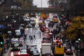 People make their way along 42nd street during a rainy day in New York