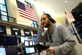 Traders work on the floor of the NYSE in New York