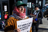 Workers picket in front of a Starbucks in the Brooklyn borough in New York