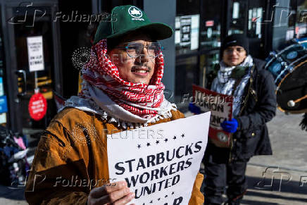 Workers picket in front of a Starbucks in the Brooklyn borough in New York