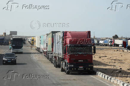 Aid trucks wait near the Rafah border crossing between Egypt and the Gaza Strip