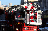 A firefighter dressed as Santa Claus greets people during Christmas season celebrations in Valparaiso