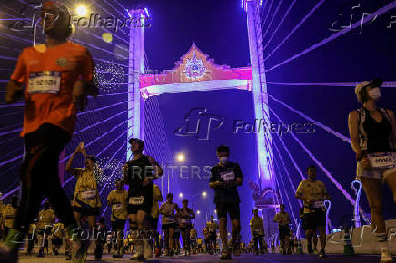 People attend a running event on the newly constructed cable-stayed Rama X Bridge or 