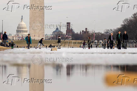 People skate on the ice-covered Lincoln Memorial Reflecting Pool on the National Mall, in Washington