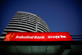 FILE PHOTO: FILE PHOTO: An illuminated signboard of IndusInd Bank is seen outside one of its branches, in New Delhi