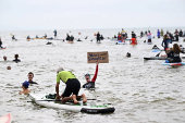 Surfers and swimmers take part in a mass ?Paddle Out? protest in Brighton