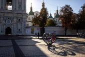 People walk near a memorial to fallen Ukrainian service members in St Sophia Square in central Kyiv