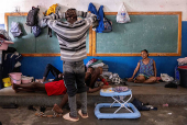 People displaced by gang war violence take refuge at the Antenor Firmin high school in Port-au-Prince