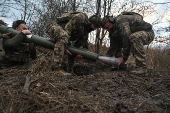 Policemen of the 'Khyzhak' Brigade extract a shell from a mortar during fire towards Russian troops at their position in a front line near the town of Toretsk