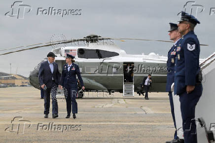 U.S. President Joe Biden is greeted by Commander of the 89th Airlift Wing at Joint Base Andrews