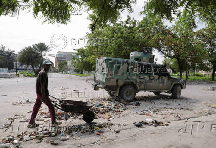A man walks past an army vehicle near the National Palace, in Port-au-Prince