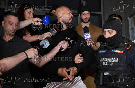 FILE PHOTO: Andrew Tate and his brother Tristan are escorted outside the DIICOT in Bucharest