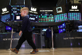 Traders and kids work on the floor of the NYSE in New York