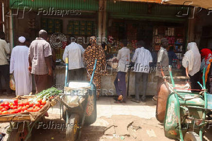 FILE PHOTO: Sudanese buy their groceries from a local vendor during the month of Ramadan in the city of Omdurman