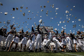 FILE PHOTO: Graduating cadets toss their hats into the air at the end of the 2023 graduation ceremony at the United States Military Academy at West Point, New York.