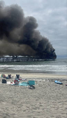 Plums of smoke rise following a fire at the pier, in Oceanside