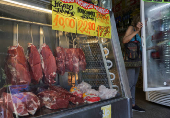 Pieces of meat hang at a butcher shop in Rio de Janeiro