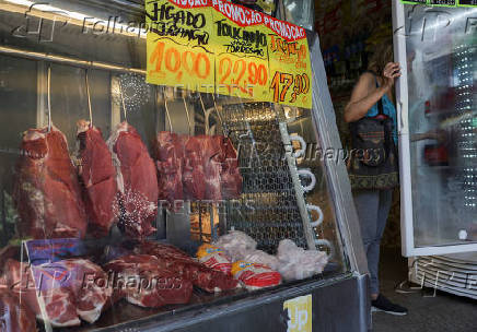 Pieces of meat hang at a butcher shop in Rio de Janeiro