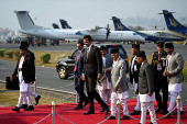 Nepal's President Ram Chandra Poudel walks with Qatar's Emir Sheikh Tamim Bin Hamad Al Thani at Tribhuvan International Airport, Kathmandu