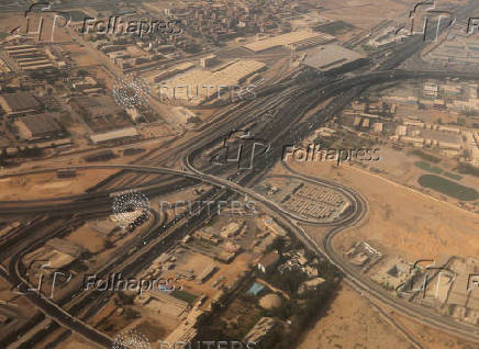 An aerial view shows bridges and new roads with Cairo's traffic, and the Adly Mansour Transportation Hub and interchange station