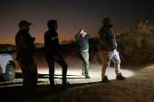 Migrants are detained by U.S. Border Patrol agents in New Mexico