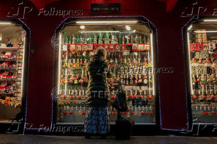 A woman looks at holiday ornaments at a pop-up Holiday shop in New York City