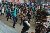 Law enforcers charge batons to disperse followers gathered to demand the release of their leader Chinmoy Krishna Das, at the Chattogram Metropolitan Magistrate Court, in Chattogram