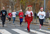 Runners wearing Santa Claus-themed outfits take part in the 