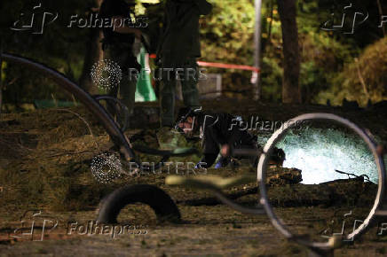 Israeli emergency services work at the scene of a missile strike, in Jaffa, south of Tel Aviv