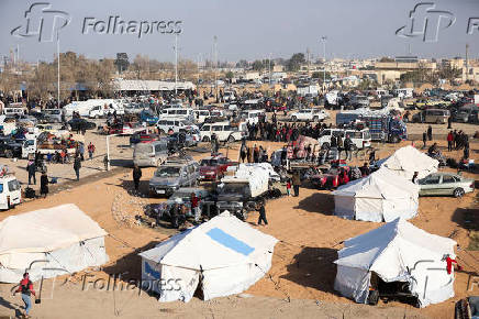 Displaced people who fled from Aleppo countryside, gather near tents in Tabqa