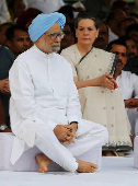 FILE PHOTO: Indian Prime Minister Singh and chief of India's ruling Congress party Gandhi sit after paying respect at the memorial of the former India's Prime Minister Rajiv on the occasion of Rajiv's 68th birth anniversary in New Delhi