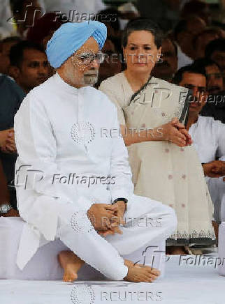 FILE PHOTO: Indian Prime Minister Singh and chief of India's ruling Congress party Gandhi sit after paying respect at the memorial of the former India's Prime Minister Rajiv on the occasion of Rajiv's 68th birth anniversary in New Delhi