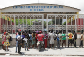 People stand outside a fire station after hearing that donated food would be distributed, in Port-au-Prince