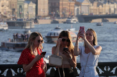 Women use their mobile phones in Saint Petersburg
