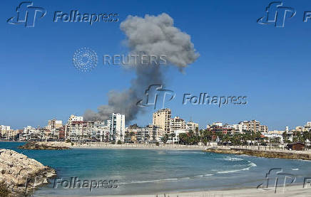 Smoke billows after an Israeli strike, amid the ongoing hostilities between Hezbollah and Israeli forces, in Tyre