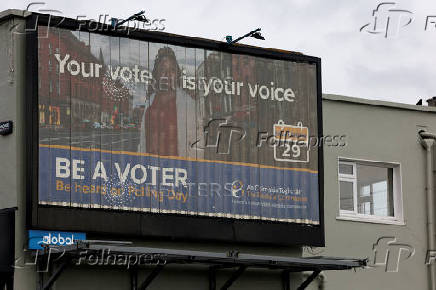 A sign encouraging people to vote is displayed on a building, in Greystones