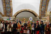 People dressed in traditional clothes sing carols inside a metro in Kyiv