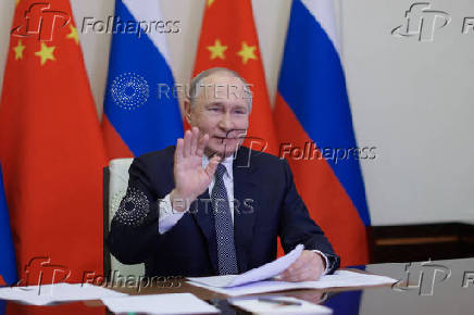 Russian President Vladimir Putin holds a video conference meeting with Chinese President Xi Jinping, outside Moscow