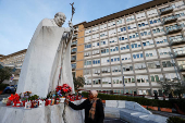 Members of the media gather outside the Gemelli Hospital where Pope Francis is admitted to continue treatment for ongoing bronchitis, in Rome