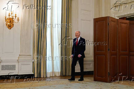 U.S. President Biden walks after signing into law a bill providing new aid to Ukraine for its war with Russia in Washington