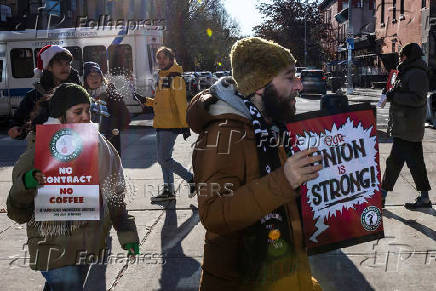 Workers picket in front of a Starbucks in the Brooklyn borough in New York